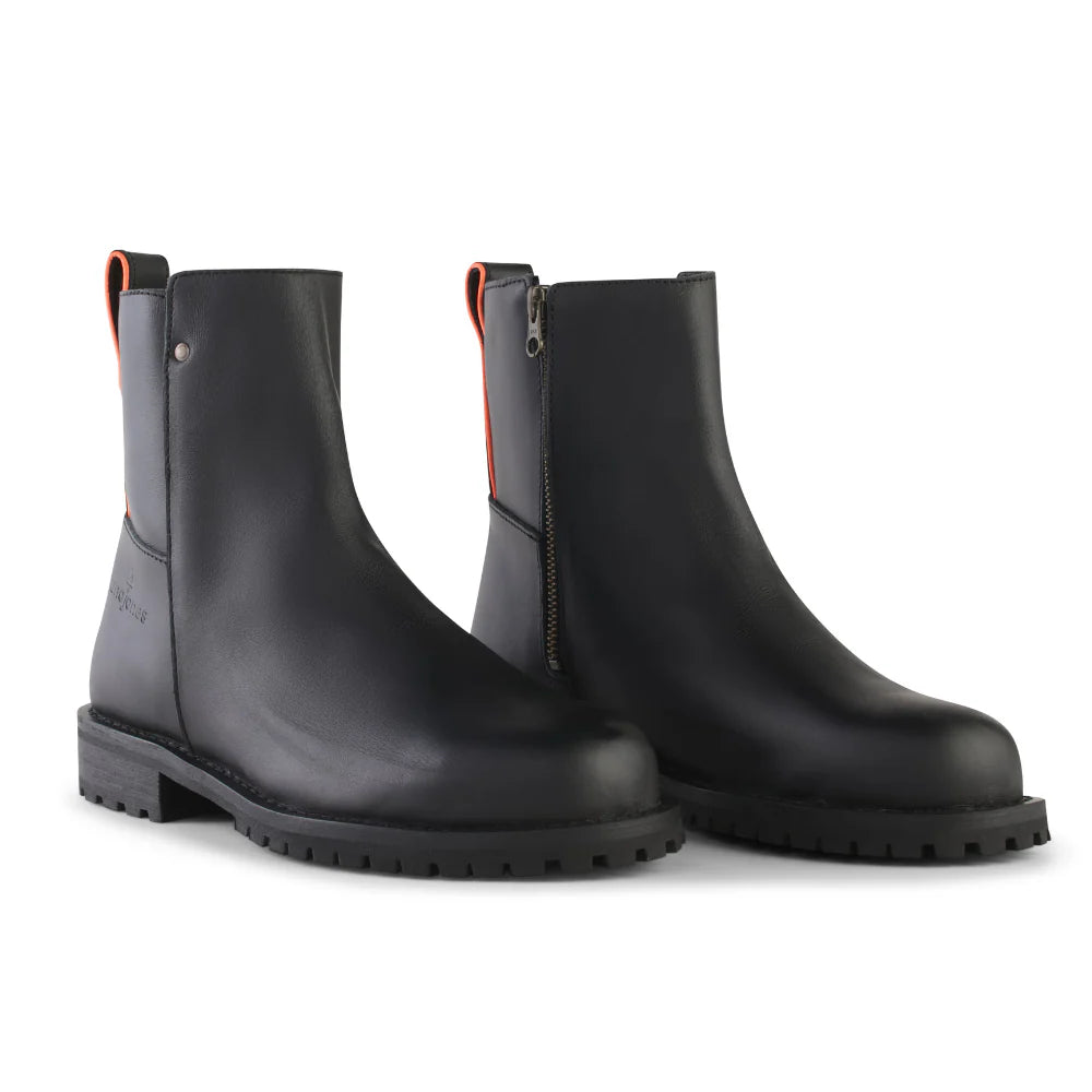 Women’s Meti steel toe work boots in Raven black full-grain leather with side zipper, slip resistant outsole, and high visibility orange pull tab side view